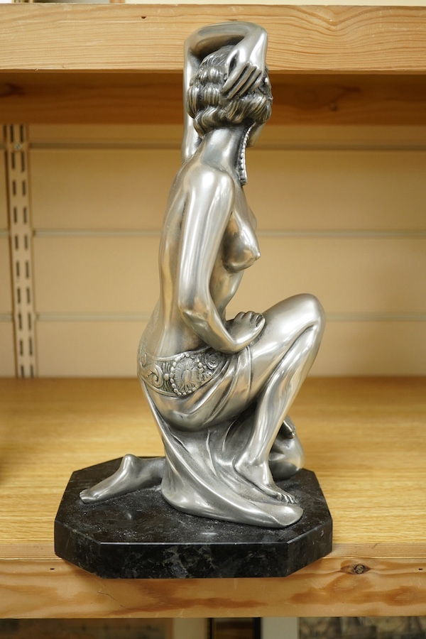 An Art Deco style figure of semi nude woman, raised on shaped marble base, in the style of Giuseppe Bessi, 37cm high. Condition - good